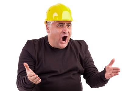 Angry construction worker looking at something isolated on white backgroundの写真素材