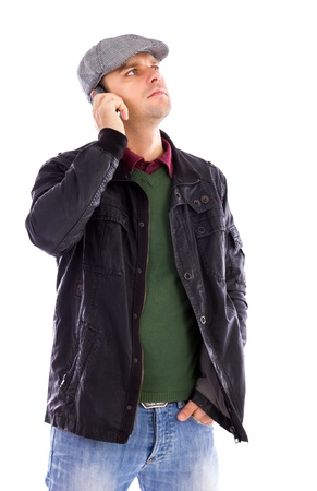 Portrait of handsome young man talking on the phone and looking up, isolated on white backgroundの写真素材