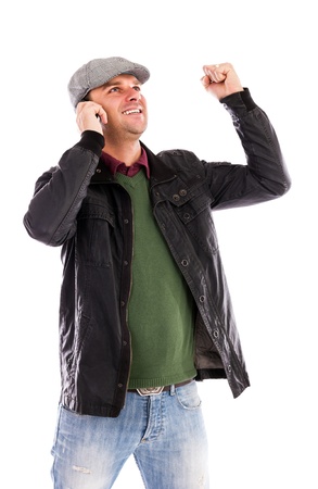     Happy young man with mobile phone receiving some great news over white background
の写真素材