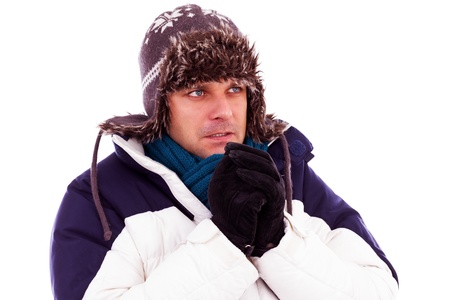 Young man rubbing his hands from cold in wintertimeの写真素材