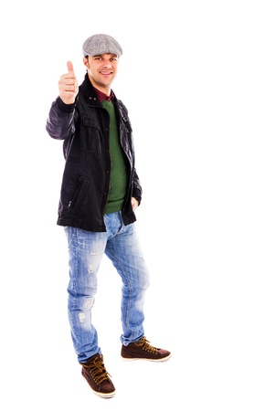 Happy young man smiling and showing thumb up, isolated on white backgroundの写真素材
