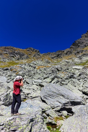 Young tourist  taking photos  during a hiking trip の写真素材