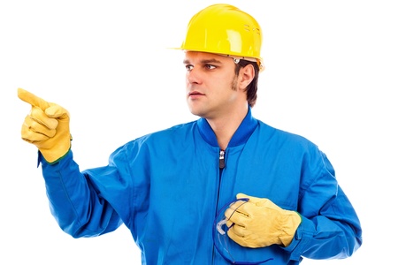 Portrait of a young construction worker pointing something isolated on white background