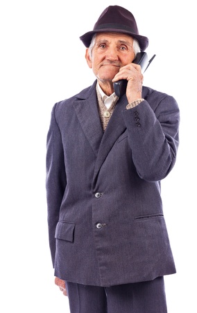 Portrait of a  senior talking on phone isolated on white backgroundの写真素材