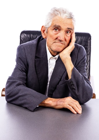Portrait of a serious elderly man looking at camera isolated on white backgroundの写真素材