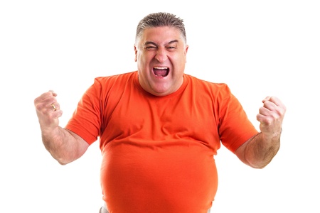 Excited  man celebrating success with hands raised against white backgroundの写真素材