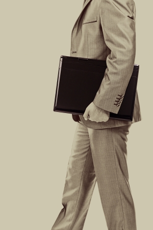 Businessman with laptop under his arm.Monochrome portraitの写真素材