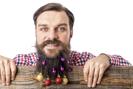 Closeup portrait of a funny man with decoration balls in his beard over white backgroundの写真素材