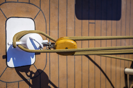 Wooden pulley with ropes on a shipの写真素材