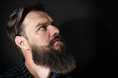 Studio shot of a handsome stylish man with beard and mustacheの写真素材