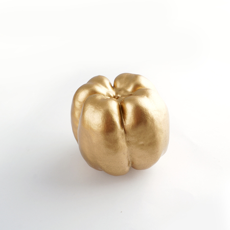 bell pepper made by gold isolated on white background.の写真素材