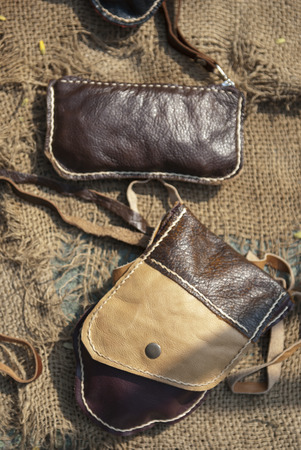 Collection of handmade leather handbags on stall at the bazaar, womanly accessoriesの写真素材