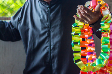Ribbon Garland in the old man's hand.の写真素材