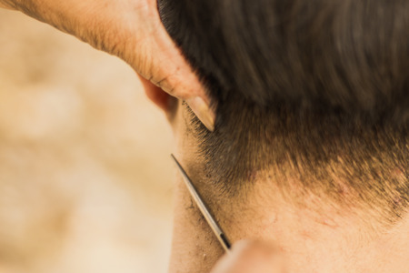 Male client getting haircut by razor.の写真素材