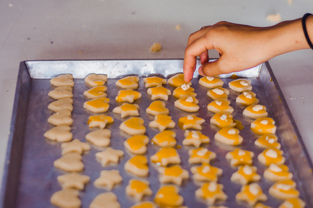 Student 's hand makes Singapore cookies from dough in school.の写真素材