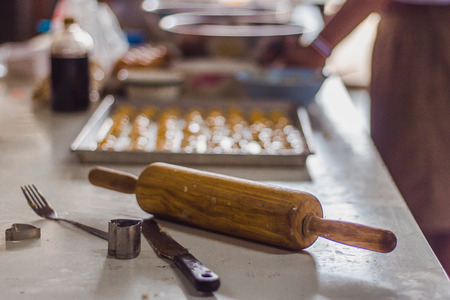 Students making cookies from dough in school.