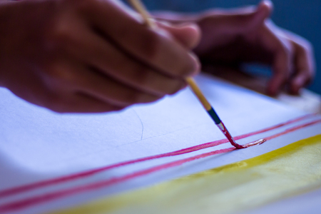 Thai students are testing the use of brushes with poster color.の写真素材