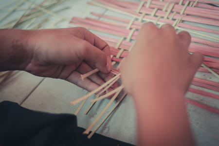 Closeup to hand of Thai students grade 4 in primary school are weaving pattern thai.の写真素材