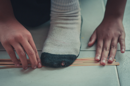 Closeup to hand of Thai students grade 4 in primary school are weaving pattern thai.