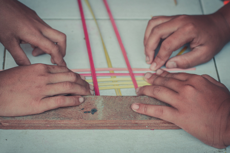 Closeup to hand of Thai students grade 4 in primary school are weaving pattern thai.の写真素材