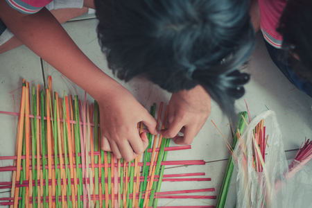 Closeup to hand of Thai students grade 4 in primary school are weaving pattern thai.の写真素材