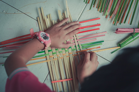 Closeup to hand of Thai students grade 4 in primary school are weaving pattern thai.の写真素材