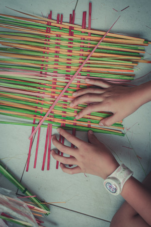 Closeup to hand of Thai students grade 4 in primary school are weaving pattern thai.の写真素材
