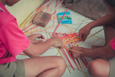 Closeup to hand of Thai students grade 4 in primary school are weaving pattern thai.の写真素材