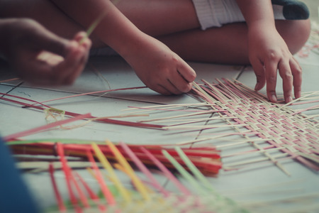 Closeup to hand of Thai students grade 4 in primary school are weaving pattern thai.の写真素材