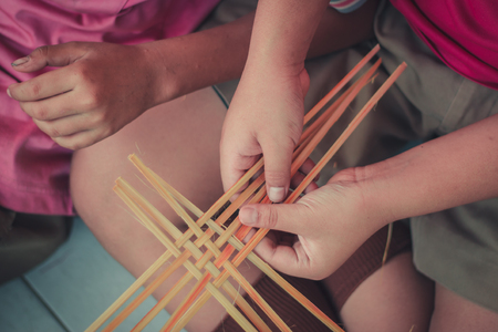 Closeup to hand of Thai students grade 4 in primary school are weaving pattern thai.の写真素材