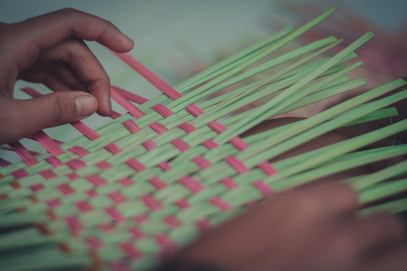 Closeup to hand of Thai students grade 4 in primary school are weaving pattern thai.の写真素材
