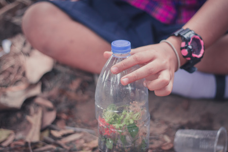 Closeup to Students are planting trees in plastic bottles.の写真素材