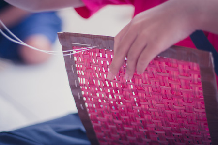 Closeup to hand of Thai students grade 4 in primary school are weaving pattern thai.の写真素材