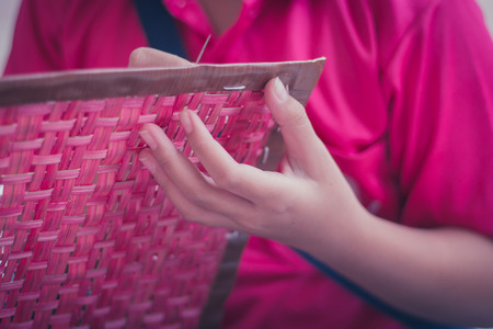 Closeup to hand of Thai students grade 4 in primary school are weaving pattern thai.