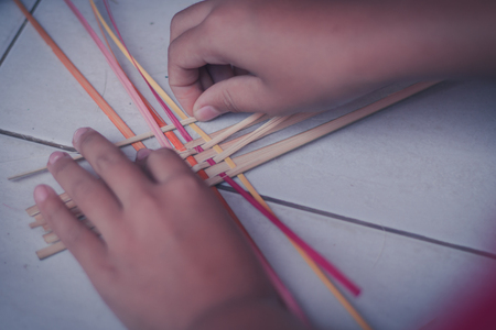 Closeup to hand of Thai students grade 4 in primary school are weaving pattern thai.の写真素材