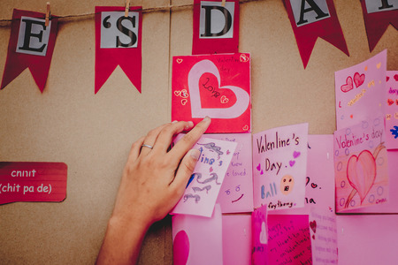 Secondary school students make Valentine cards on a board.の写真素材