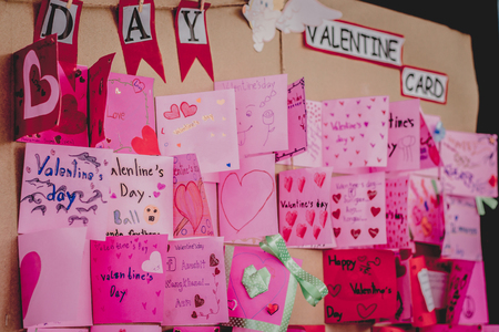 Secondary school students make Valentine cards on a board.の写真素材