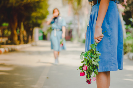 Rose with female students on valentine's day in school.の写真素材