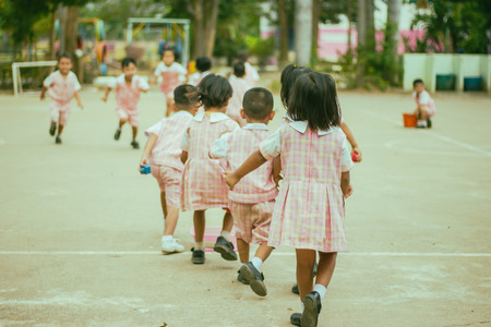 Kindergarten children prepare for exercise in morning.