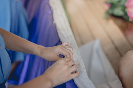 Close-up to Student hands are decorating the curtains.
Decorate the stageの写真素材