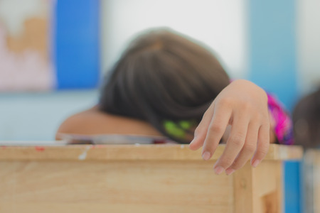 A Student sleeps during the final exam in classroom.の写真素材