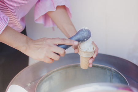 Close-up to Teacher 's handsGive ice cream to students.の写真素材