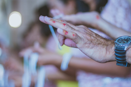 Handfasting. Selective focus on hands of Thai graduation ceremony.
