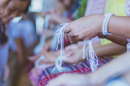 Handfasting. Selective focus on hands of Thai graduation ceremony.の写真素材