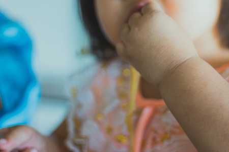 Kindergarten student is eating Pad Thai in school.の写真素材