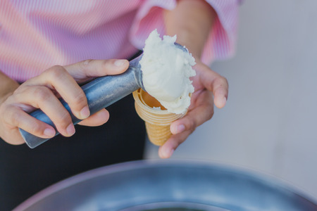 Close-up to Teacher 's hands give ice cream to students.の写真素材