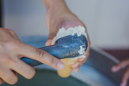 Close-up to Teacher 's hands give ice cream to students.の写真素材