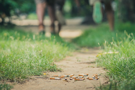 No Smoking concept. Smoking student is running away from his teacher in school. Selective focus on...