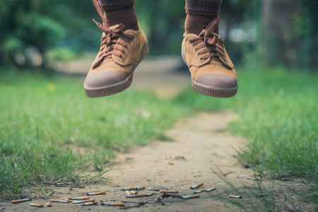 No smoking concept. Student trying to give up smoking in school. Selective focus on cigarette butt.の写真素材