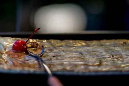 The last cherry on an ice cream dish for the best eat.の写真素材